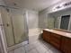 Spacious bathroom featuring dual sinks, a soaking tub, and a separate glass-enclosed shower at 6545 Netherseal Ave, Las Vegas, NV 89139