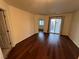 A relaxing bedroom featuring hardwood floors, neutral walls, and a sliding glass door to the balcony at 6545 Netherseal Ave, Las Vegas, NV 89139