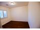 Bright bedroom with hardwood floors, a large window for natural light, and a serene ambiance at 6545 Netherseal Ave, Las Vegas, NV 89139