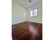 Bedroom with hardwood flooring, a window with blinds, and neutral walls at 6545 Netherseal Ave, Las Vegas, NV 89139