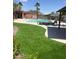 Community pool area with lounge chairs, turf, and cabana at 6545 Netherseal Ave, Las Vegas, NV 89139
