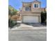 Two-story home featuring a large two-car garage, balcony, and well-kept beige stucco at 6545 Netherseal Ave, Las Vegas, NV 89139