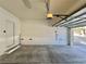 Attached garage with a concrete floor and automatic door opener; door is partially open at 6545 Netherseal Ave, Las Vegas, NV 89139