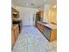 Functional kitchen featuring stainless steel appliances, ample cabinet space, and neutral tile flooring at 6545 Netherseal Ave, Las Vegas, NV 89139