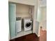 Compact laundry closet with a stacked washer and dryer unit at 6545 Netherseal Ave, Las Vegas, NV 89139