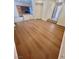 Open-concept space showcasing hardwood floors and connectivity to the kitchen at 6545 Netherseal Ave, Las Vegas, NV 89139