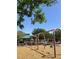 Community playground featuring a swing set, wood chip ground cover, and gazebo at 6545 Netherseal Ave, Las Vegas, NV 89139