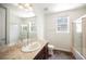 Bathroom with a tub and shower combination, framed mirror, and neutral color palette at 68 E Serene Ave # 224, Las Vegas, NV 89123