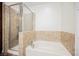 Bright bathroom with white tub and tiled shower at 68 E Serene Ave # 224, Las Vegas, NV 89123