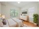 Bedroom featuring wood floors, a window, dresser, and a large houseplant at 68 E Serene Ave # 224, Las Vegas, NV 89123