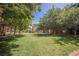Lush green common area for residents surrounded by trees and residential buildings on a sunny day at 68 E Serene Ave # 224, Las Vegas, NV 89123
