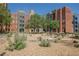 Common area in the condominiums with seating areas, tables and desert landscaping at 68 E Serene Ave # 224, Las Vegas, NV 89123