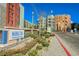 Manhattan Condominiums entrance with manicured landscaping and view of buildings on a beautiful sunny day at 68 E Serene Ave # 224, Las Vegas, NV 89123