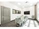 Conference room with large glass table, executive chairs, TV and modern lighting at 68 E Serene Ave # 224, Las Vegas, NV 89123