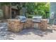 Outdoor community grill station with two stainless steel grills, stone base and nearby seating at 68 E Serene Ave # 224, Las Vegas, NV 89123