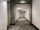 Hallway featuring neutral paint and carpet leading to units at 68 E Serene Ave # 224, Las Vegas, NV 89123