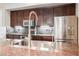 This kitchen showcases a stainless steel sink with granite countertops and wooden cabinets at 68 E Serene Ave # 224, Las Vegas, NV 89123