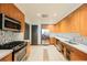 Updated kitchen features wood cabinets, stainless steel appliances, backsplash, and lots of counter space at 68 E Serene Ave # 224, Las Vegas, NV 89123