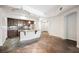 Open concept kitchen with stainless steel appliances, dark cabinetry, and stone floors at 68 E Serene Ave # 224, Las Vegas, NV 89123