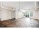 Open living space boasts stone tile flooring, recessed lighting and glass sliding doors to the outside at 68 E Serene Ave # 224, Las Vegas, NV 89123