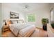 Staged main bedroom featuring hardwood floors, recessed lights, a ceiling fan and a large bed at 68 E Serene Ave # 224, Las Vegas, NV 89123