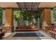 Community covered patio with outdoor seating, a fire pit, and manicured foliage at 68 E Serene Ave # 224, Las Vegas, NV 89123