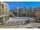Community pool with sundeck and seating for residents, surrounded by colorful buildings at 68 E Serene Ave # 224, Las Vegas, NV 89123