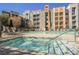 Community pool and spa area with lounge chairs and manicured landscaping at 68 E Serene Ave # 224, Las Vegas, NV 89123
