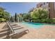 Tranquil community pool surrounded by lush greenery, offering a peaceful outdoor experience at 68 E Serene Ave # 224, Las Vegas, NV 89123