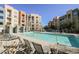 Relaxing pool area with lounge chairs and lush greenery at 68 E Serene Ave # 224, Las Vegas, NV 89123