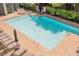 Well-maintained pool with lounge chairs, umbrellas, and lush greenery, offering a relaxing environment at 68 E Serene Ave # 224, Las Vegas, NV 89123