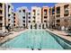 Community pool surrounded by lounge chairs and manicured landscaping at 68 E Serene Ave # 224, Las Vegas, NV 89123
