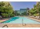 Resort-style pool with ample deck space and stylish lounge chairs, with modern building in background at 68 E Serene Ave # 224, Las Vegas, NV 89123