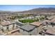 Wide aerial view of homes, community amenities, and desert landscape in the distance at 6848 Sunflower Fields St, North Las Vegas, NV 89086