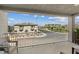 This covered balcony features a black metal railing with views of the neighborhood and mountains beyond at 6848 Sunflower Fields St, North Las Vegas, NV 89086