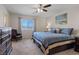 Comfortable bedroom with blue bedding, neutral carpet, dresser and lots of natural light at 6848 Sunflower Fields St, North Las Vegas, NV 89086
