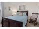 Comfortable bedroom with a wooden rocking chair and matching wooden bed with decorative pillows and soft blue bedding at 6848 Sunflower Fields St, North Las Vegas, NV 89086