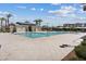 Community swimming pool with lounge chairs and umbrellas for relaxing by the water at 6848 Sunflower Fields St, North Las Vegas, NV 89086