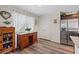 Dining area with dark wood floors, natural light, and dark cabinets and stainless steel appliances at 6848 Sunflower Fields St, North Las Vegas, NV 89086