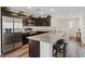 Modern kitchen featuring dark cabinets, granite countertops, and stainless steel appliances at 6848 Sunflower Fields St, North Las Vegas, NV 89086