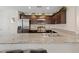 Kitchen with stainless steel appliances, granite countertops, and dark wood cabinetry at 6848 Sunflower Fields St, North Las Vegas, NV 89086