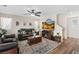 Comfortable living room boasts stylish furniture, entertainment center, and modern ceiling fan at 6848 Sunflower Fields St, North Las Vegas, NV 89086