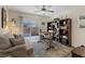 Cozy living room with a ceiling fan, a comfortable couch, a patterned rug, and a sliding glass door to the backyard at 6848 Sunflower Fields St, North Las Vegas, NV 89086