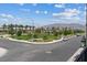 Street view in the community, showing sidewalks, green spaces and mountain views in the distance at 6848 Sunflower Fields St, North Las Vegas, NV 89086