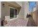 Enclosed patio with brick pavers, gray stucco, and low-maintenance rock landscaping at 6848 Sunflower Fields St, North Las Vegas, NV 89086