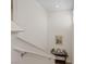 Bright staircase with neutral paint, white railing and a small table at 6848 Sunflower Fields St, North Las Vegas, NV 89086