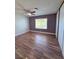 This bedroom features luxury vinyl flooring, ceiling fan, and window for natural light at 7123 Kenwood St, Las Vegas, NV 89147