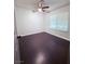 This bedroom features dark luxury vinyl flooring and a ceiling fan at 7123 Kenwood St, Las Vegas, NV 89147