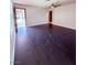 Spacious living room featuring ceiling fan and dark wood-look flooring at 7123 Kenwood St, Las Vegas, NV 89147