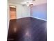 Spacious living room featuring dark wood-look floors and ceiling fan at 7123 Kenwood St, Las Vegas, NV 89147